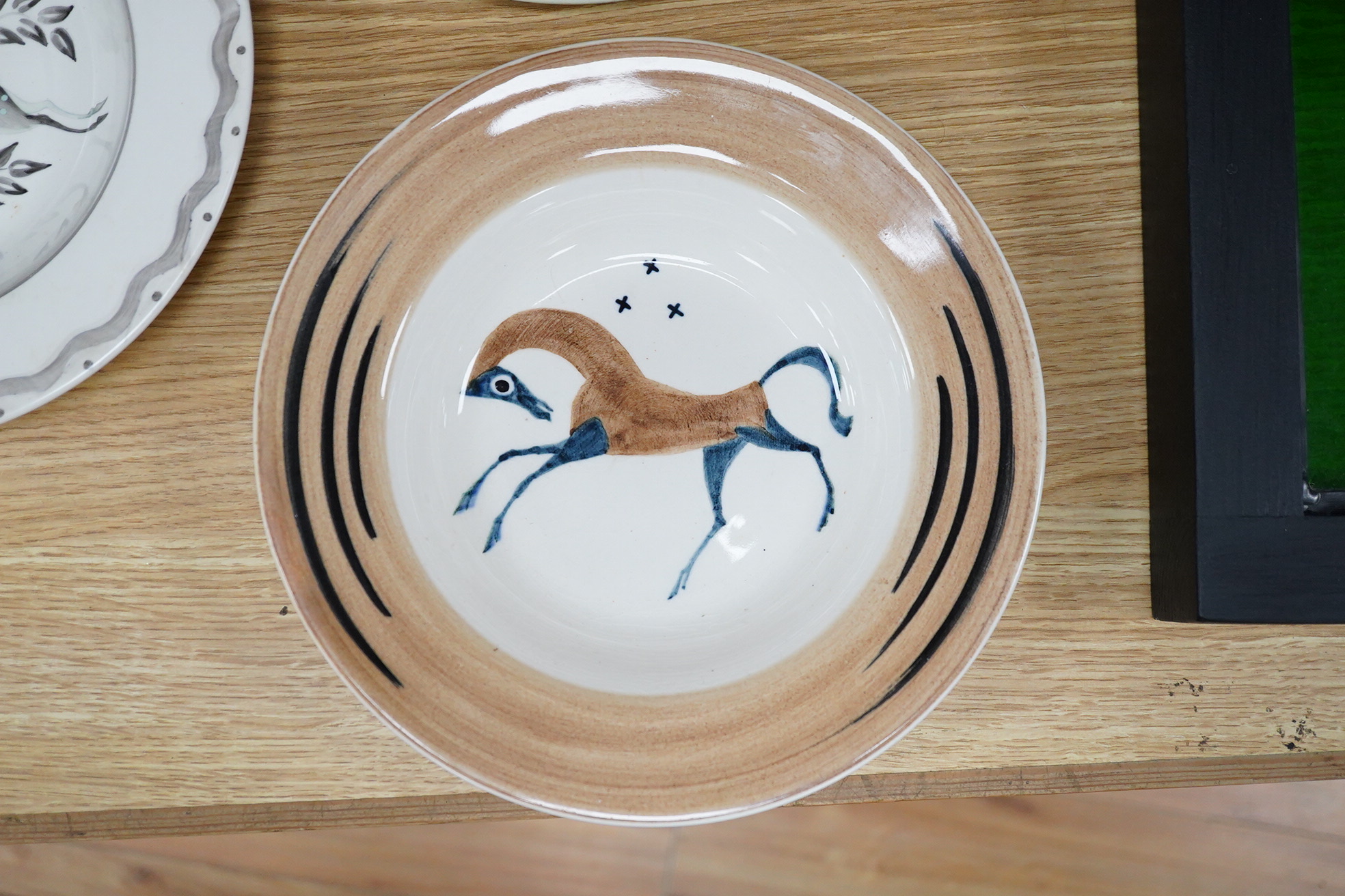 A Billie Waters Clarice Cliff Bizarre bowl, John Armstrong Bizarre bowl and an Ernest Proctor plate, 23cm in diameter